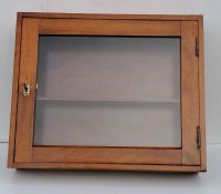 A late 19th century oblong hanging walnut display case with interior shelf and glazed door, with key