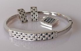 A diamond and sapphire parure on 18ct white gold comprising bangle, earrings and pendant