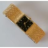 A vintage Marvin black face square dial watch with baton markers, 23mm, with a textured gold bark ef