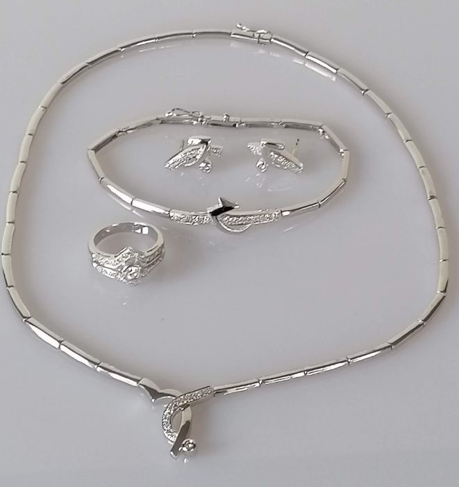 A parure comprising of a white gold articulated necklet with integral pendant and diamond decoration