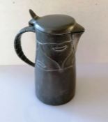 A Liberty & Co Tudric pewter flagon, circa 1900, with hinged lid and handle and stylized impressed d