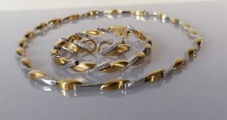 A white and yellow gold parure with diamond decoration comprising a necklace, 40 cm, bracelet 17cm a