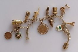 A yellow and white gold charm bracelet, all hallmarked 9ct, 29.5g