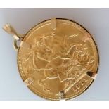 A George V gold full sovereign in a 9ct gold mount, 8.78g