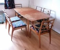A mid-century Mackintosh & Co teak extending dining table and six chairs (4+2 carvers) with fabric u