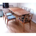 A mid-century Mackintosh & Co teak extending dining table and six chairs (4+2 carvers) with fabric u