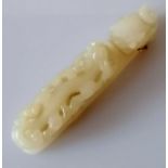 A 19th century Chinese white jade belt buckle hook with carved dragon head and chilong surmount to s