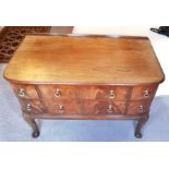 An early 20th century mahogany dressing chest with shaped top, a combination of six drawers with bra