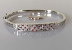A ruby and diamond bangle on an 18ct white gold setting with matching ring;