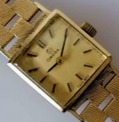 A vintage ladies gold Omega watch with graduated textured bracelet strap, hallmarked 9ct, in working