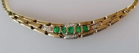 An emerald and diamond pendant necklace, 38 cm and an oval cabochon coral ring in a gold setting, si