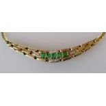 An emerald and diamond pendant necklace, 38 cm and an oval cabochon coral ring in a gold setting, si