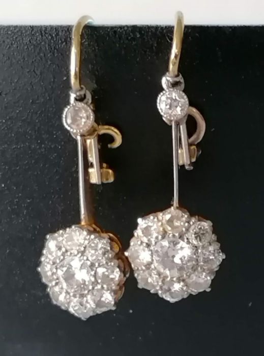A pair of white and yellow metal diamond earrings, the central round-cut diamond approximately 0.20 - Image 4 of 6