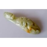 A 19th century Chinese jade belt buckle hook with dragon head carving and chilong surmount to shaft,