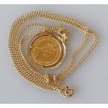 A QEII gold half sovereign, 1983, on a 9ct gold mount and chain, both hallmarked, 11.6g