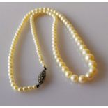 An Art Deco single row of one hundred and three graduated cultured pearls measuring 3.45mm to 7.43mm