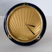 A Cartier Art Deco-style table clock with stylized face, signed, blue enamel surround on easel suppo