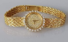 A 9ct yellow gold ladies wrist watch with diamond encrusted face, 15mm, sword hands