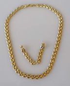 A yellow and white gold fancy-link necklace with lobster clasp and matching earrings, 40 cm,