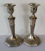 A pair of late Victorian silver candlesticks of tapering form, acanthus leaf and fluted decoration