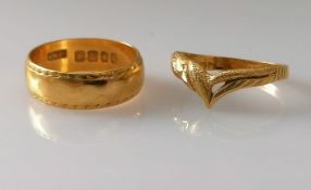 A 22ct yellow gold wedding band with etched decoration, 6mm, hallmarked and a yellow gold wishbone