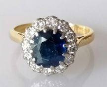 A sapphire and diamond cluster ring on an 18ct yellow gold setting, the sapphire 8 x 7mm