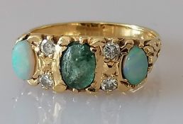 An Edwardian gold three-stone opal and diamond ring, size K, marks rubbed, tests for 14ct, 4.5g