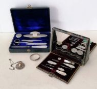 An Edwardian travel sewing kit and later nail kit; a silver child's bangle and white metal