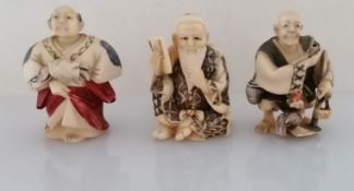 Three late 19th century Japanese carved ivory and polychrome painted netsuke figures, all signed,