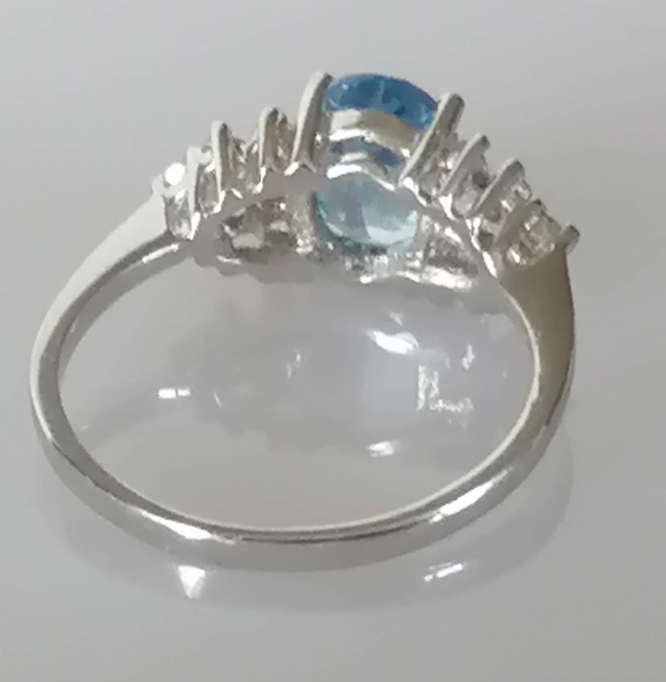 An oval blue topaz, 7 x 5mm, on white gold ring with cubic zirconia decoration to shoulders, size L, - Image 4 of 6