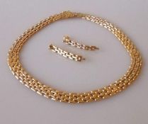 An 18ct yellow and white gold brick-link necklace and matching earrings, 41 cm, hallmarked, 41.35g