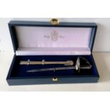 A miniature ceremonial sword/letter opener by Pooley, London, with metal scabbard and fitted case,