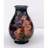 A Moorcroft 'Finches' pattern vase, tubelined with birds against a dark blue ground, impressed and