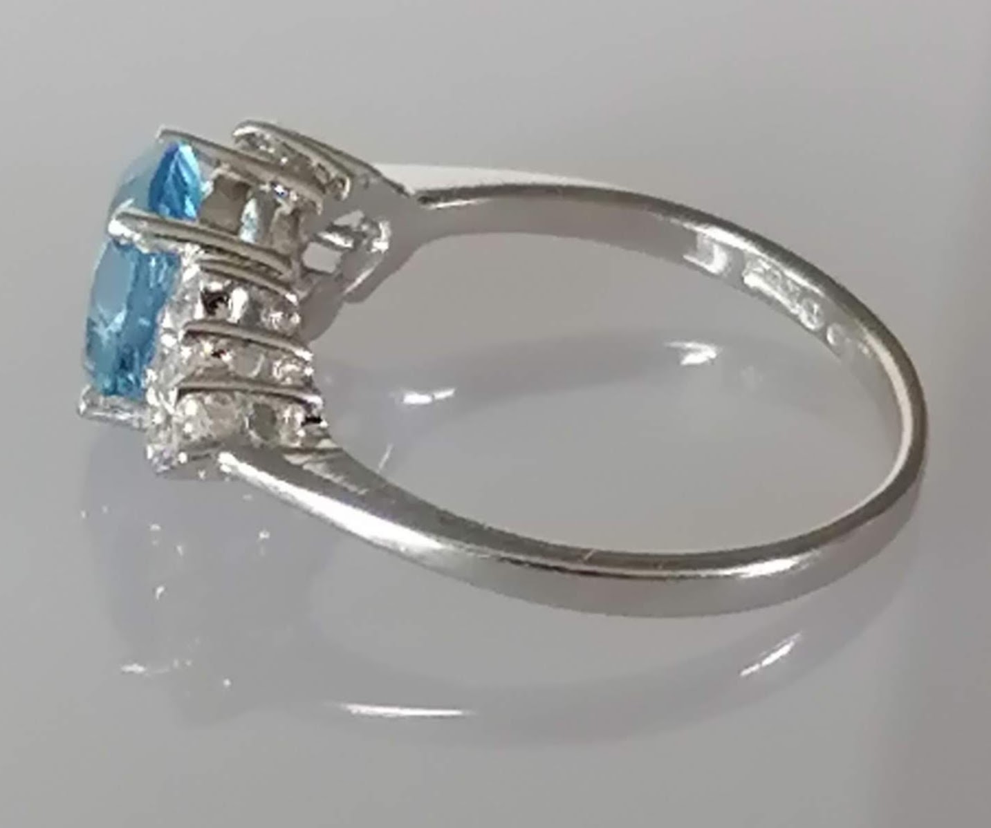 An oval blue topaz, 7 x 5mm, on white gold ring with cubic zirconia decoration to shoulders, size L, - Image 3 of 6
