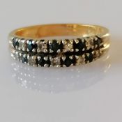 A diamond and sapphire channel-set ring on white and yellow gold, unmarked but tests for 18ct,