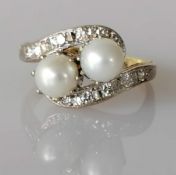 An Art Deco-style pearl and diamond crossover ring on white and yellow gold, each cultured pearl