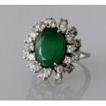 An emerald and diamond cluster ring, the oval emerald 12mm x 9mm, surrounded by twenty four round