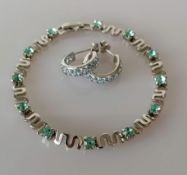 A gem-set line bracelet, 17 cm, on white metal and a pair of blue topaz on white gold earrings,