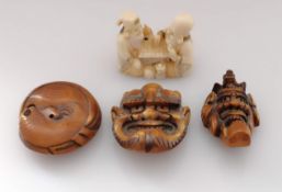Three wooden Japanese noh mask netsukes, Meiji period: Hyottoko, Oni, each 5 cm and an ivory netsuke