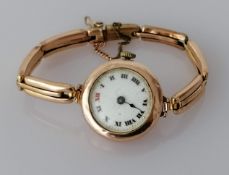 A George V rose gold-cased ladies wristwatch with roman numerals, hand missing, not in working