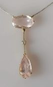 An Edwardian morganite and diamond necklace set with a pear-cut morganite 19.05 x 9.39 x 6.46mm,
