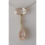 An Edwardian morganite and diamond necklace set with a pear-cut morganite 19.05 x 9.39 x 6.46mm,