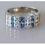 An 18ct white gold blue topaz and cubic zirconia ring, size N, hallmarked, 6g