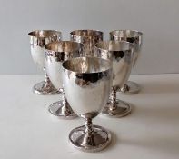 A set of six white metal goblets with planished decoration, unmarked, 11 cm H,