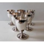 A set of six white metal goblets with planished decoration, unmarked, 11 cm H,