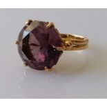A round-cut amethyst dress ring on a yellow gold claw setting, the amethyst 15mm diameter, stamped