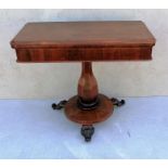 A George IV rosewood fold over card table with shaped top, plain frieze, octagonal baluster support