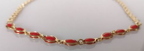 A mid-century Italian coral bead necklace on a yellow gold fancy-link chain, 38 cm, stamped 750