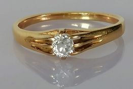 A late Victorian diamond ring with an old mine-cut diamond, weighing a calculated 0.40 carat,