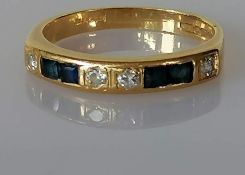 A sapphire and diamond-set half-hoop ring comprising four round brilliant-cut diamonds